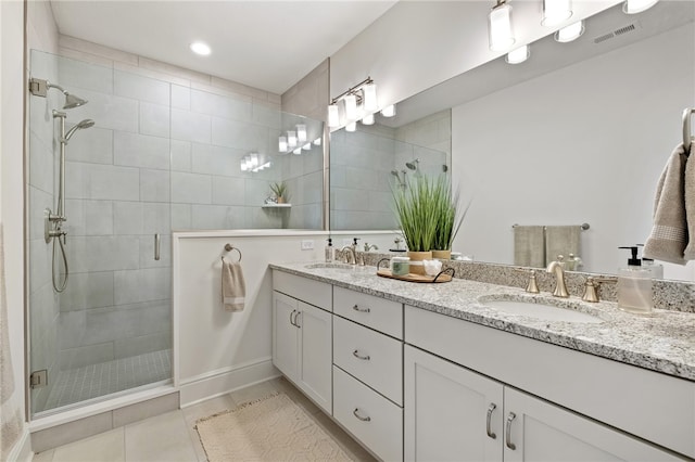 bathroom featuring vanity, walk in shower, and tile patterned flooring