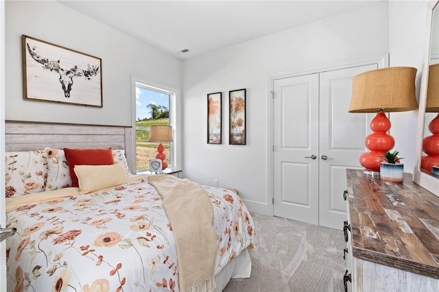 bedroom featuring a closet and light carpet