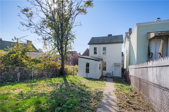 rear view of house featuring central AC unit