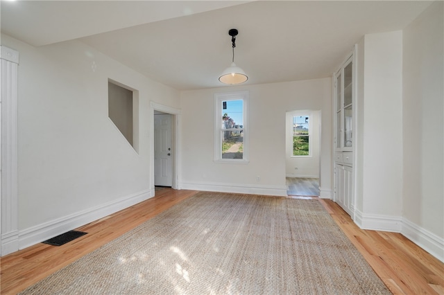 unfurnished dining area with light hardwood / wood-style flooring