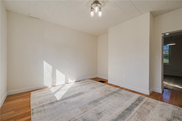 unfurnished room with wood-type flooring