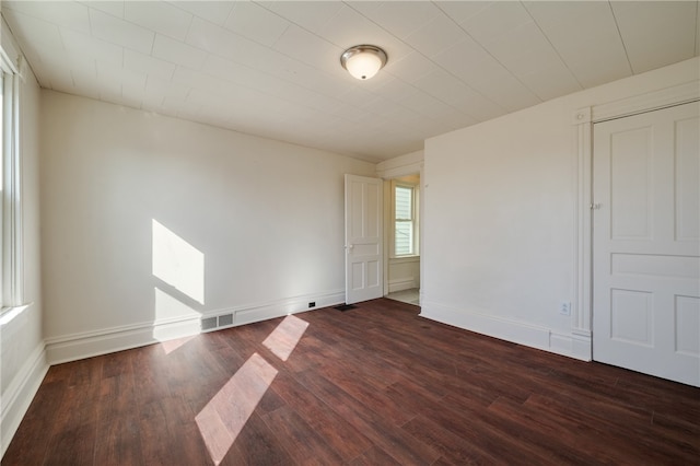 spare room with dark wood-type flooring