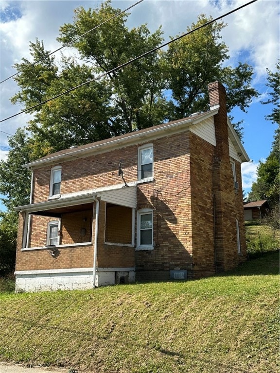 view of property exterior featuring a lawn