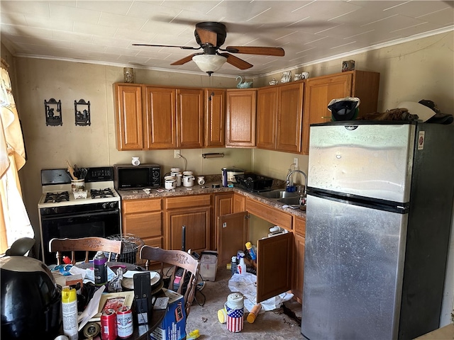 kitchen with white gas range oven, sink, stainless steel fridge, crown molding, and ceiling fan