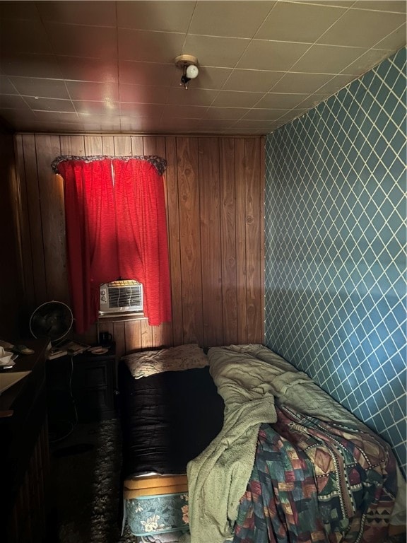 bedroom featuring wooden walls