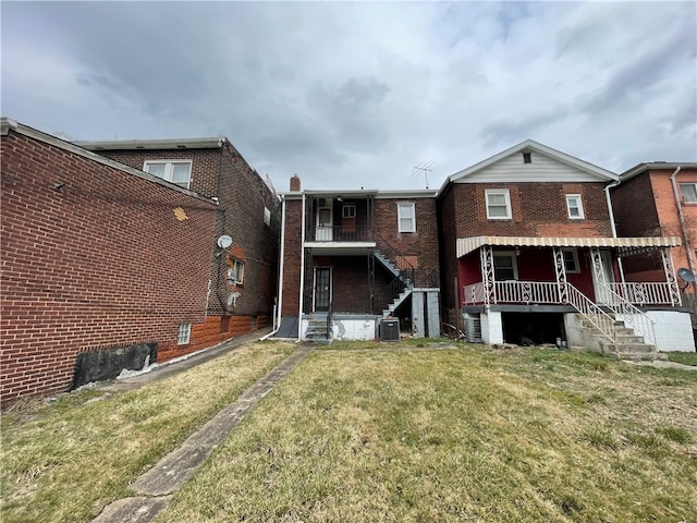 back of property featuring a yard and cooling unit