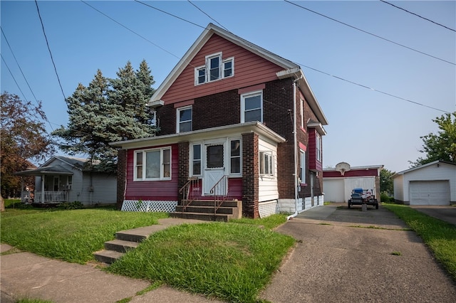 view of front property featuring a front lawn, an outbuilding, and a garage