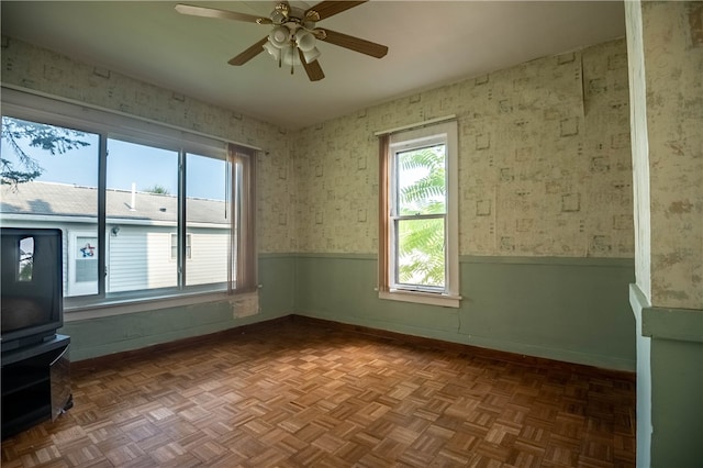 interior space with parquet floors and ceiling fan