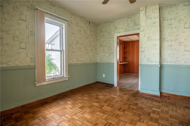 unfurnished room featuring parquet floors and ceiling fan