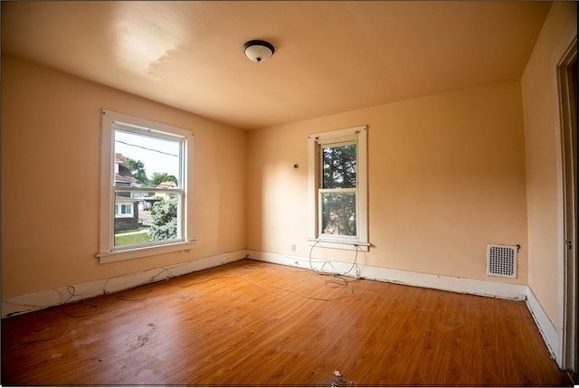 unfurnished room featuring hardwood / wood-style floors