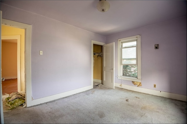 unfurnished bedroom featuring light carpet