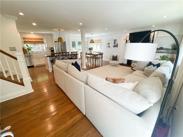 living room featuring crown molding and hardwood / wood-style flooring