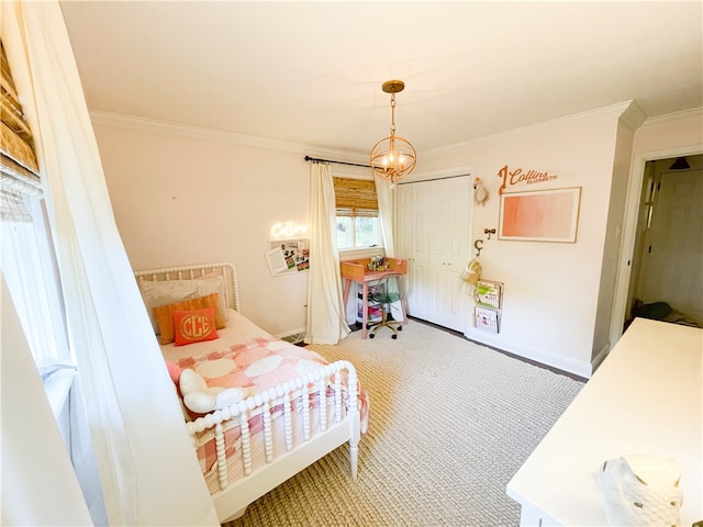 carpeted bedroom featuring a closet, a notable chandelier, and crown molding