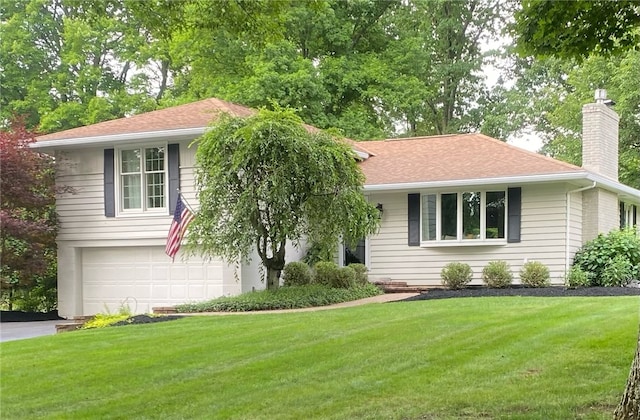 view of front of house with a front yard and a garage