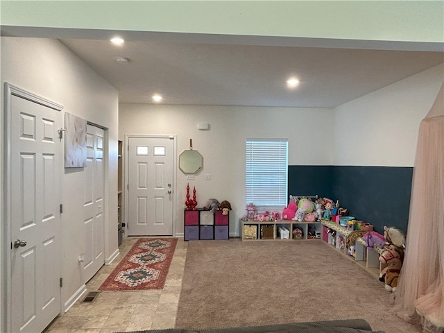 rec room with light colored carpet