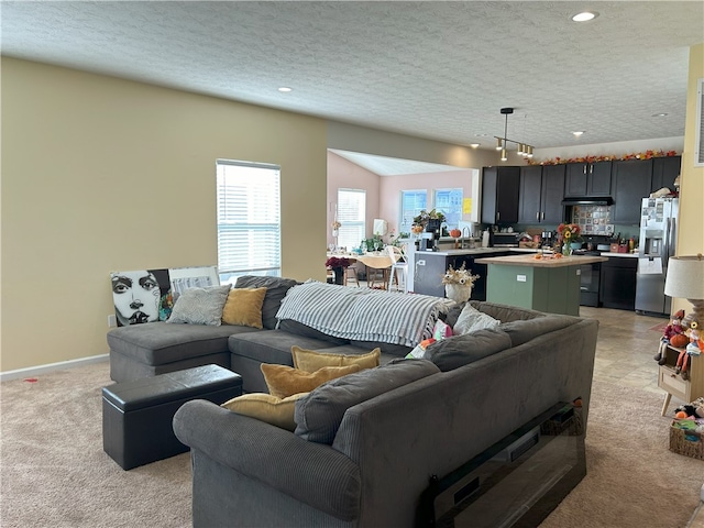 living room featuring light colored carpet and a textured ceiling