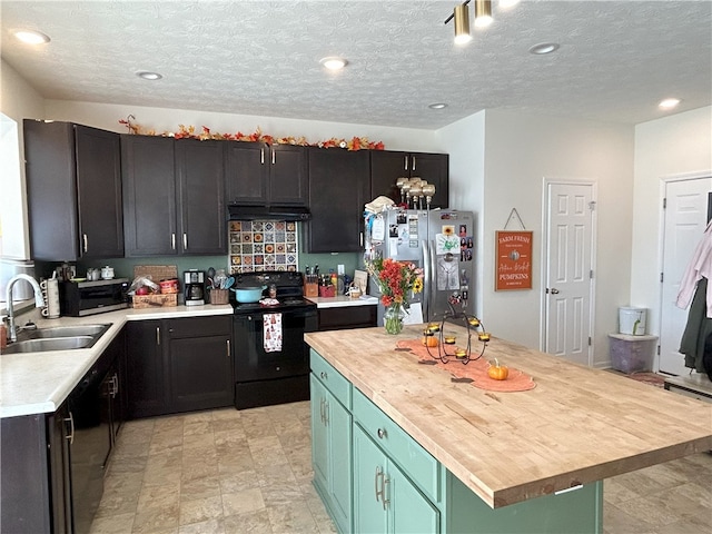 kitchen with a textured ceiling, sink, black appliances, a kitchen island, and green cabinets