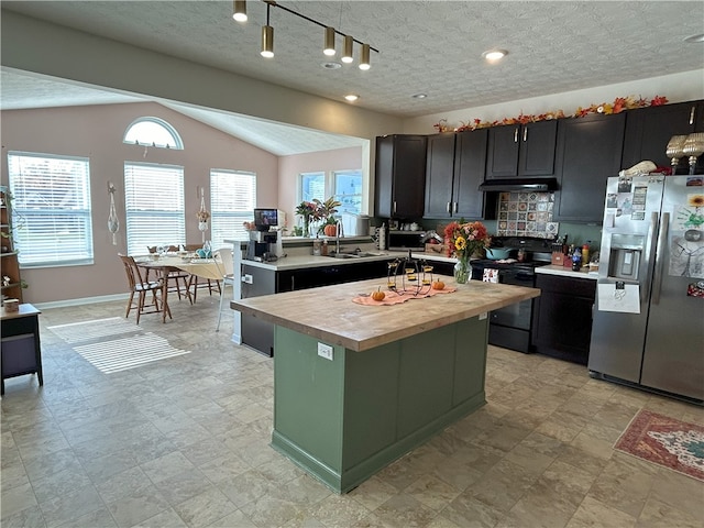 kitchen featuring a center island, sink, stainless steel fridge with ice dispenser, black electric range, and wooden counters