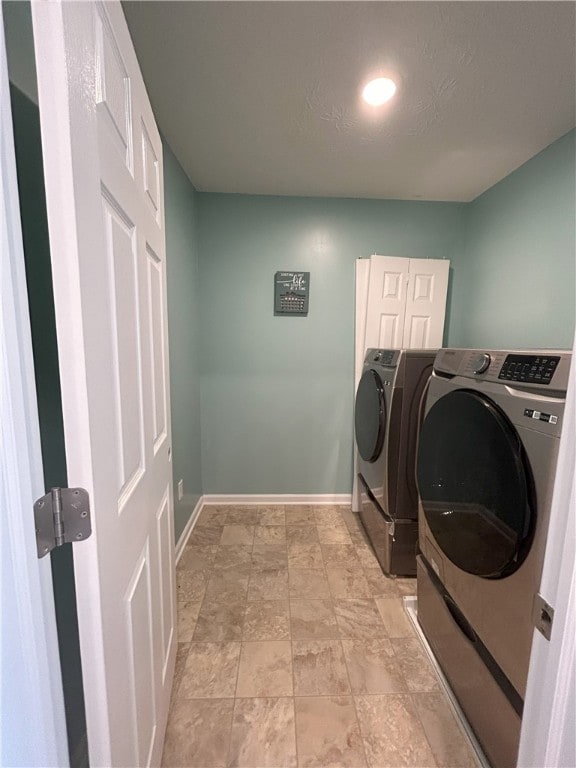 washroom with independent washer and dryer and a textured ceiling