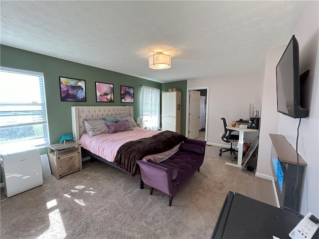 bedroom with light carpet and a textured ceiling