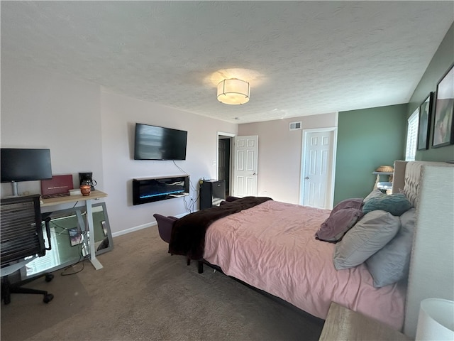 bedroom featuring carpet flooring and a textured ceiling