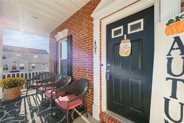 view of exterior entry with covered porch