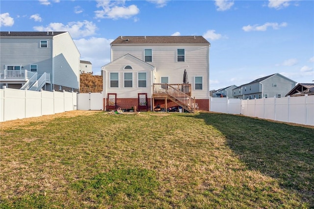 rear view of house with a lawn and a deck