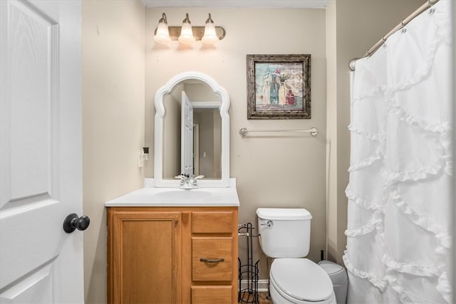 bathroom featuring toilet and vanity