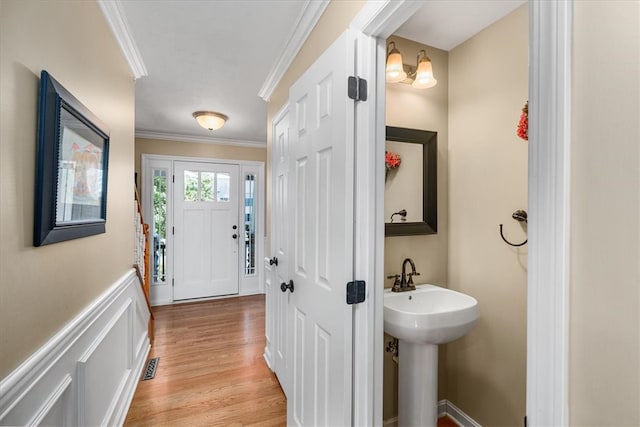 bathroom with ornamental molding and hardwood / wood-style floors