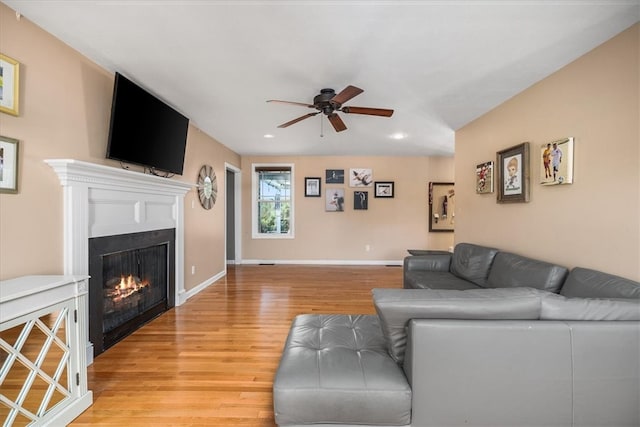 living room with ceiling fan and light hardwood / wood-style flooring