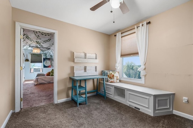 interior space with cooling unit, dark carpet, and ceiling fan