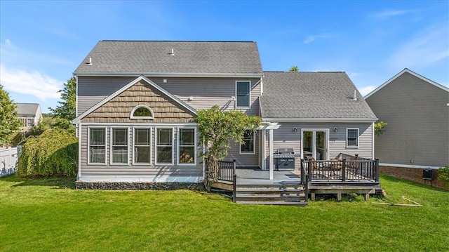 back of house featuring a deck and a lawn