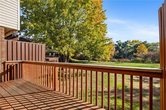 wooden terrace featuring a yard