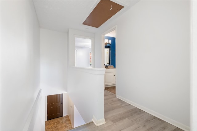 hallway with light hardwood / wood-style floors