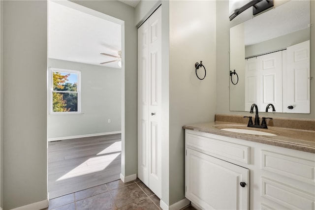 bathroom featuring vanity, ceiling fan, and wood-type flooring