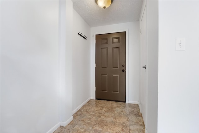 doorway featuring a textured ceiling