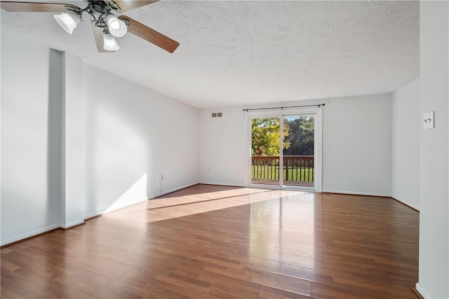 spare room with a textured ceiling, wood-type flooring, and ceiling fan