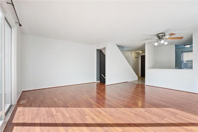 empty room featuring hardwood / wood-style flooring and ceiling fan