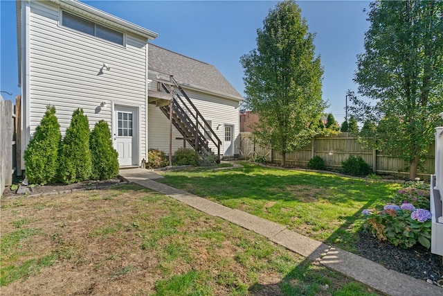 rear view of house with a lawn