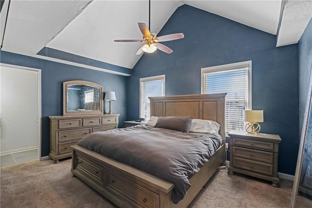 carpeted bedroom with ceiling fan and high vaulted ceiling