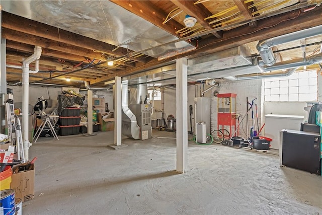 basement featuring heating unit and water heater