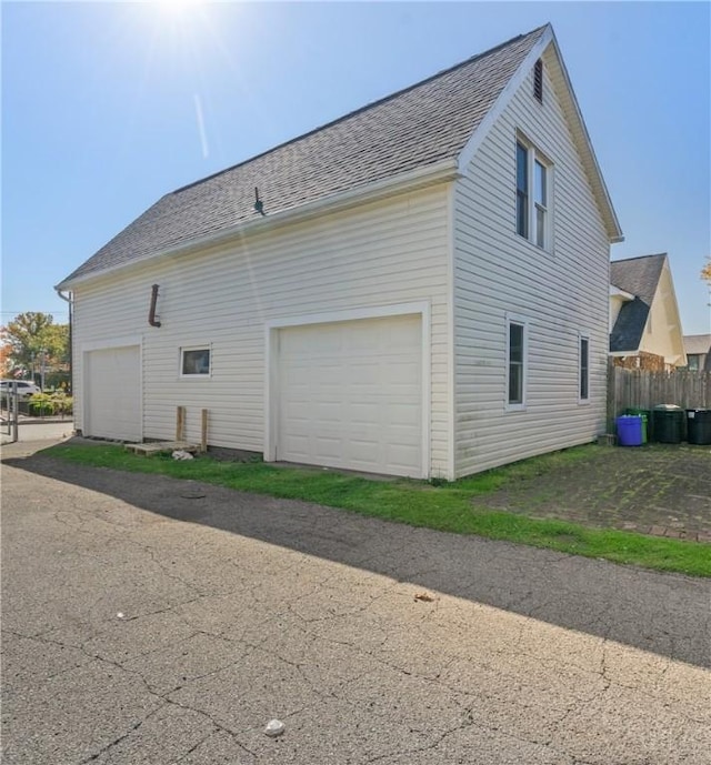 view of side of home featuring a garage