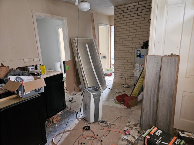 interior space featuring dark cabinets, light countertops, and water heater