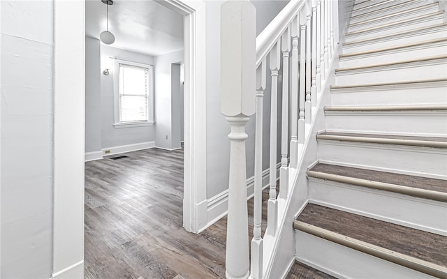 staircase with hardwood / wood-style floors