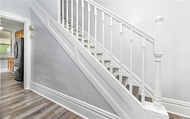 staircase with hardwood / wood-style floors