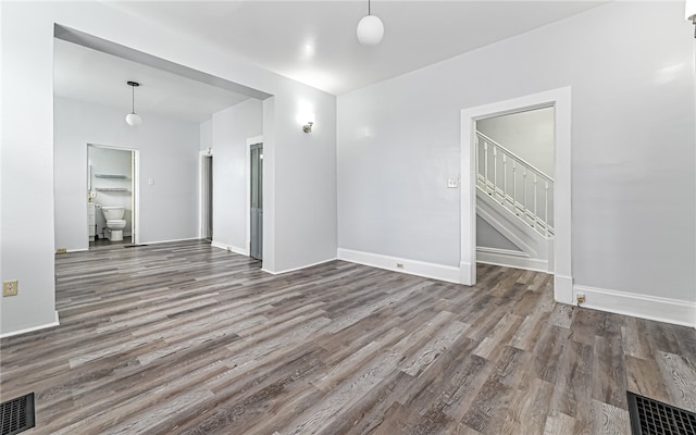 unfurnished room with wood-type flooring