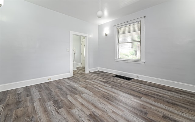 unfurnished room with wood-type flooring