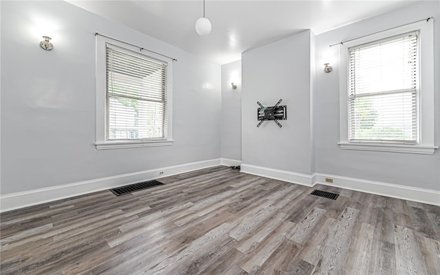 unfurnished room with hardwood / wood-style floors