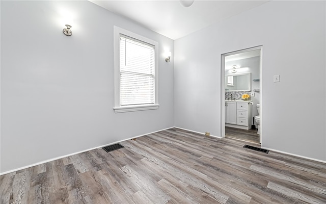 empty room with hardwood / wood-style flooring