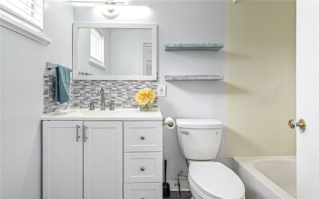 bathroom featuring a bathtub, toilet, backsplash, and vanity